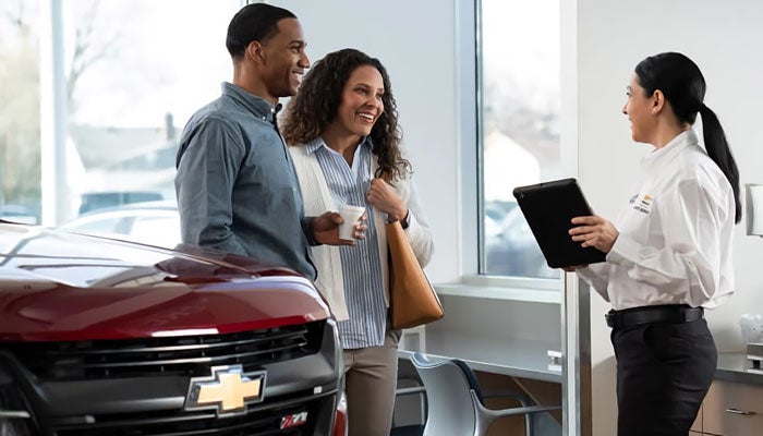 Couple car shopping at Chevrolet dealership